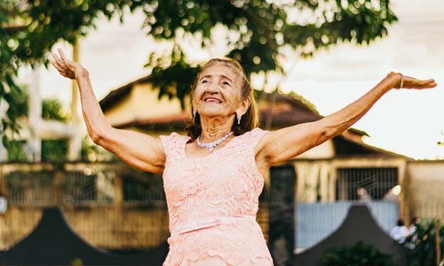 Healthy Elderly Woman Raising Hands to the Sky.