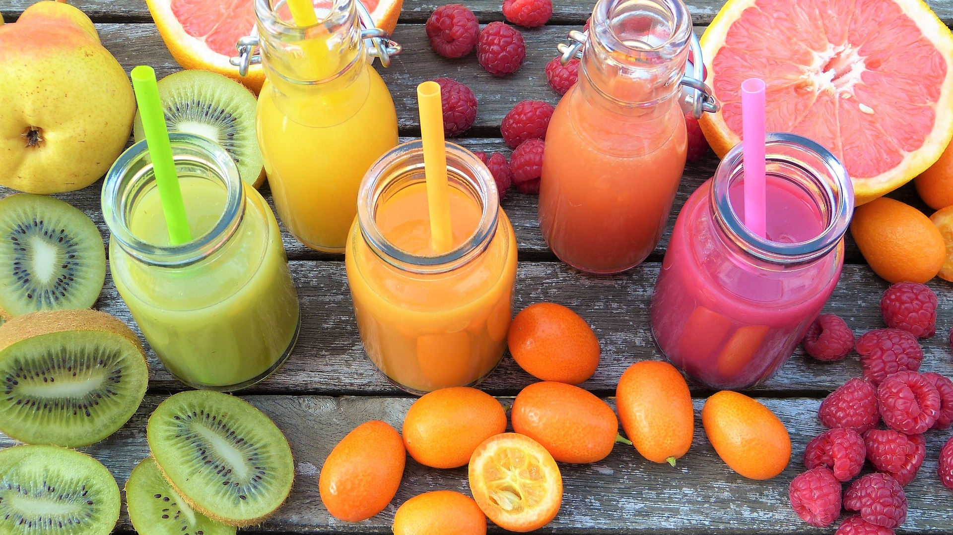 Green, orange and red smoothie made from healthy fruit juices.
