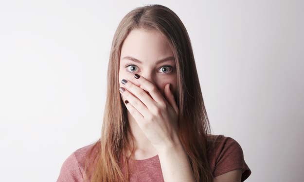 Person Hiding Mouth with Cold Sore.