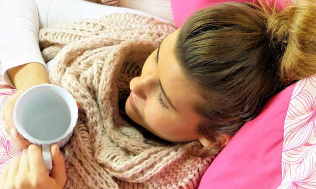 Woman with Bronchitis Resting on Couch.