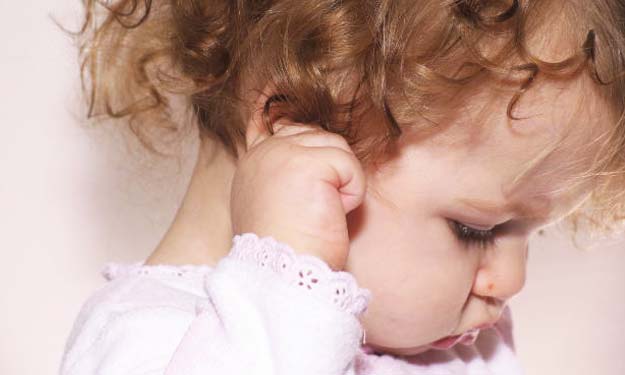 Young Child Rubbing Ear with Ear Ache.