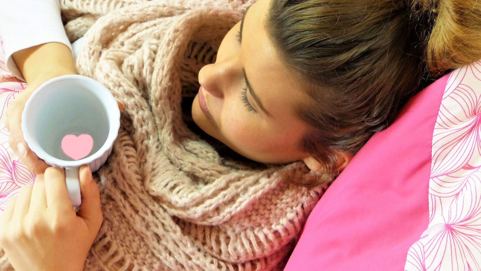 Sick woman holding a cup of tea