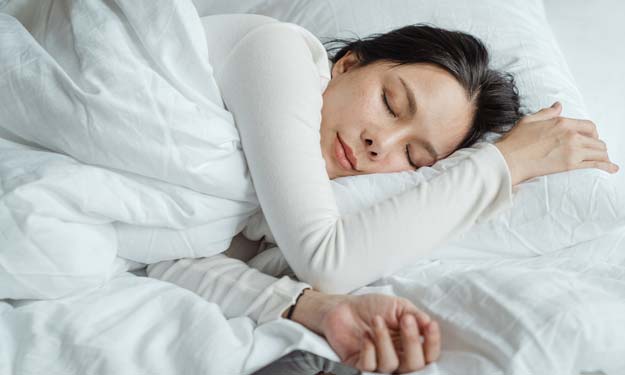 Woman Sleeping with the Help of Natural Sleep Aids.